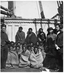 The entrance of the ‘Parihaka’ cave, looking out, and adherents of the Pai Mārire (Hauhau) faith captured by British forces at Weraroa pā, at Waitōtara, north-west of Whanganui. They are being held on a ship in Wellington Harbour in 1866, and were later imprisoned in Dunedin. (Alexander Turnbull Library 
Reference: 1/2-103605-F) 
