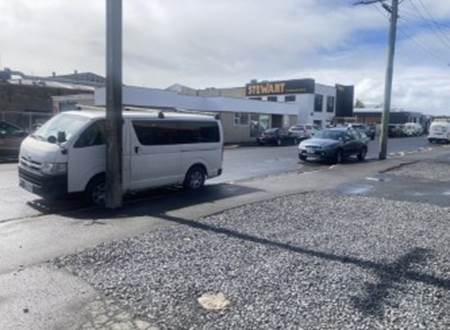 A white van parked on a street

Description automatically generated